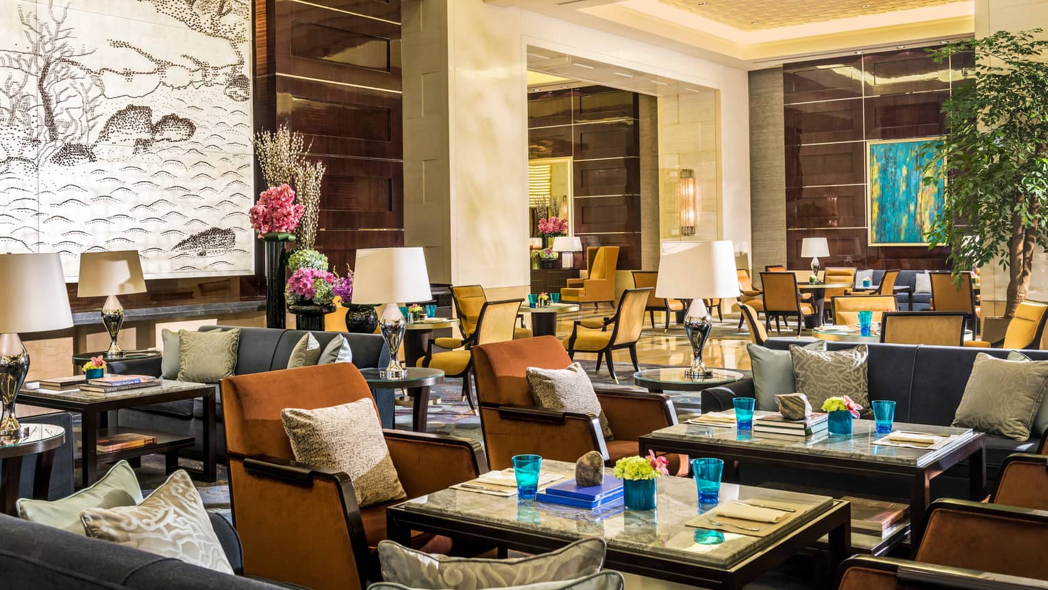 Opus Lounge dining tables, chairs in bright room with high ceilings, white archway, large painting