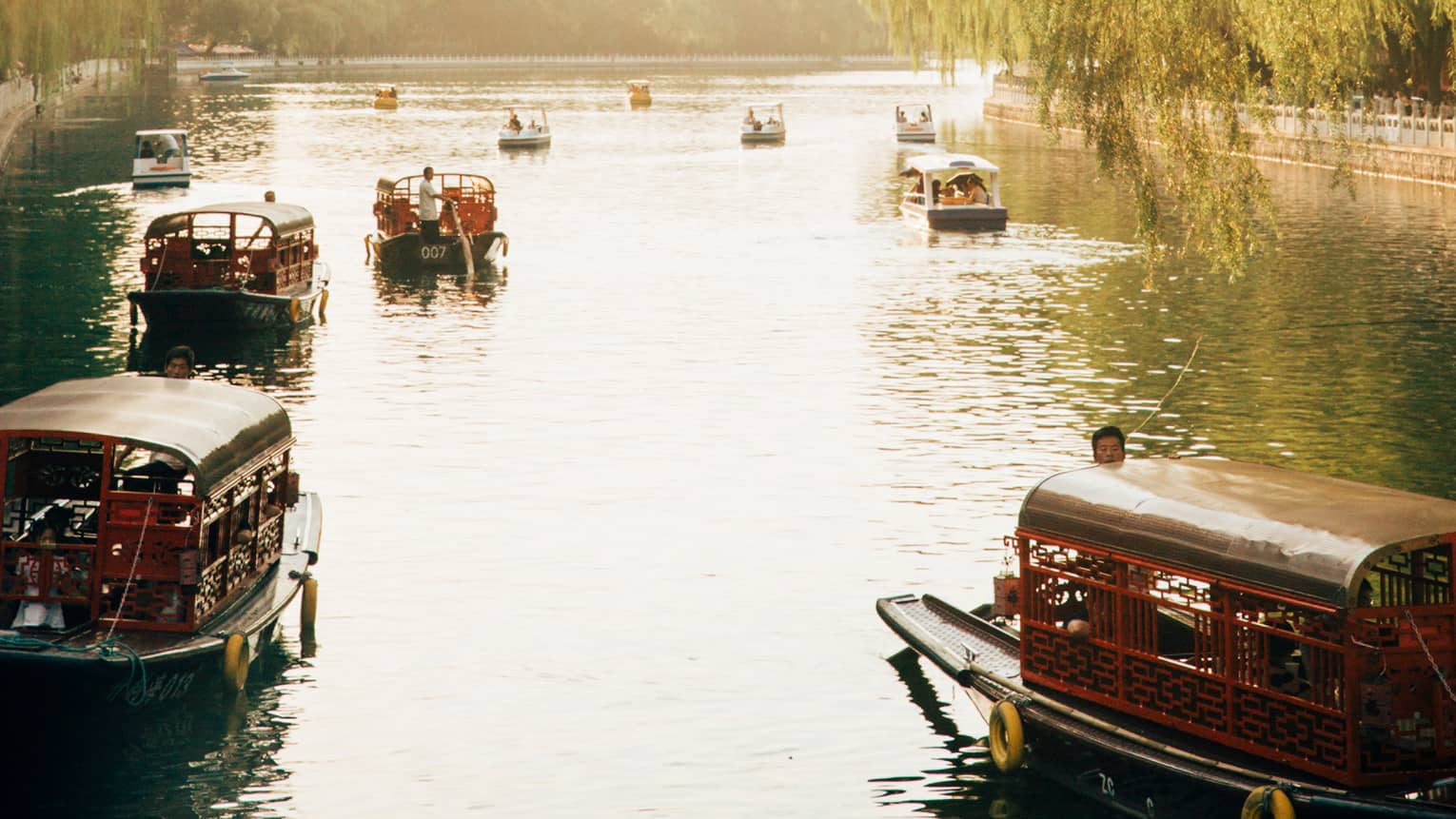 Small boats along river on sunny day
